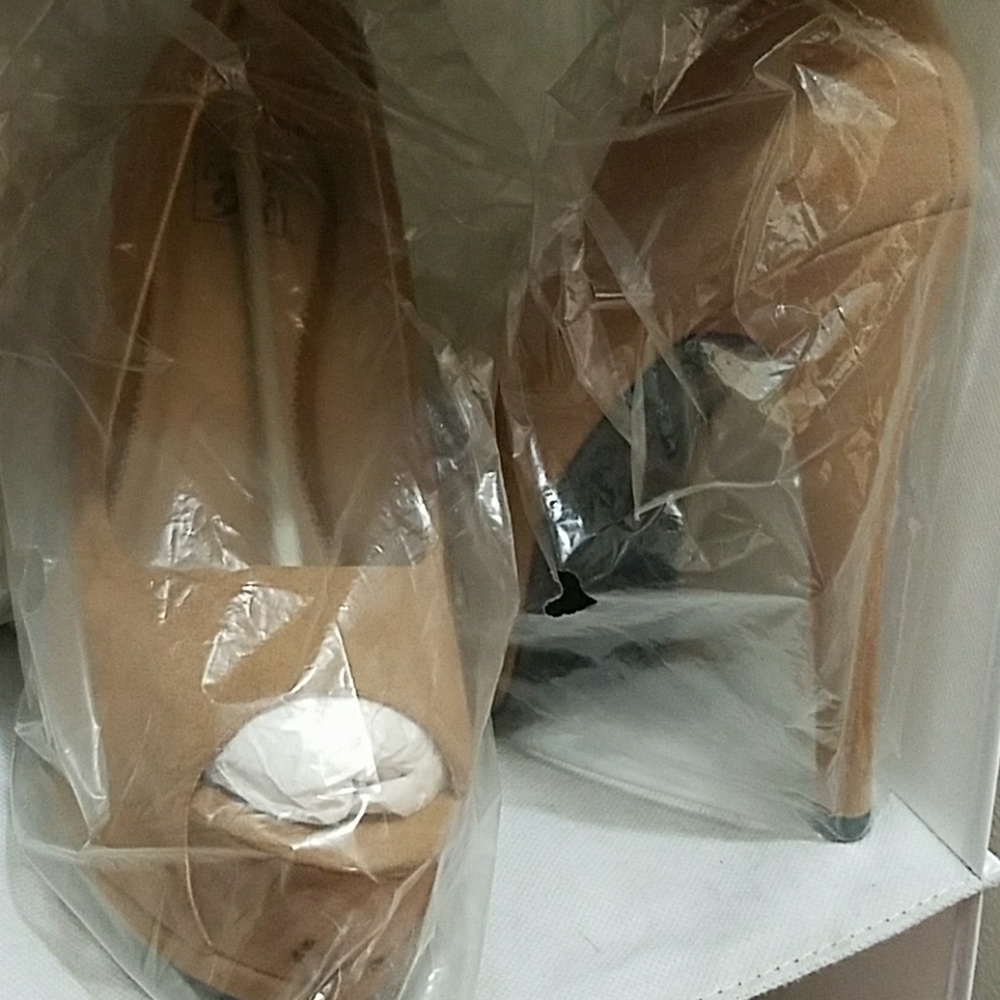 Peep toe high heeled suede pumps.